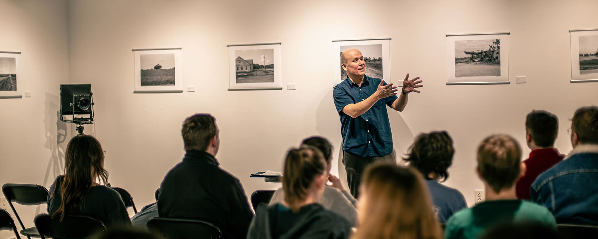 Steckline Gallery - Cary Conover presents his work to a group of students during an Art for Lunch event.