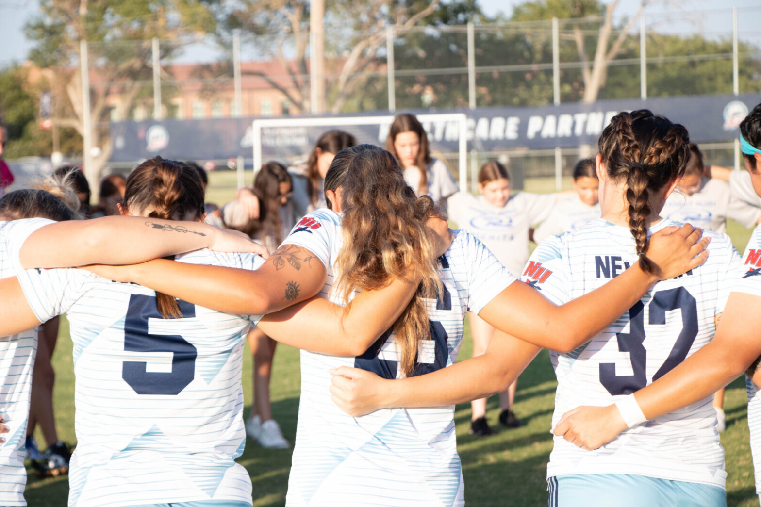 Softball player in a huddle